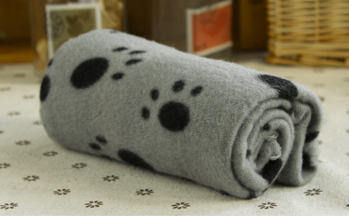 Gray fleece pet blanket with paw-print pattern, rolled