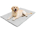 Light gray quilted travel mat with a dog lying on it
